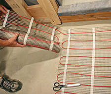 Preparing to run another row with the floor heating mat.