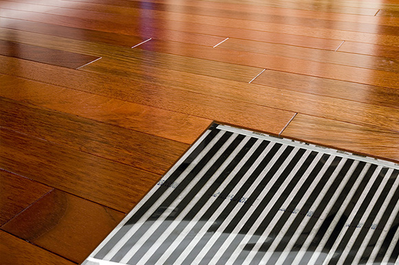 FilmHeat floor heating system installed under hardwood floor.